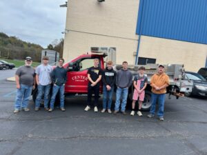 West Greene FFA students and supervisors pose in front of a Center Township truck they helped repair